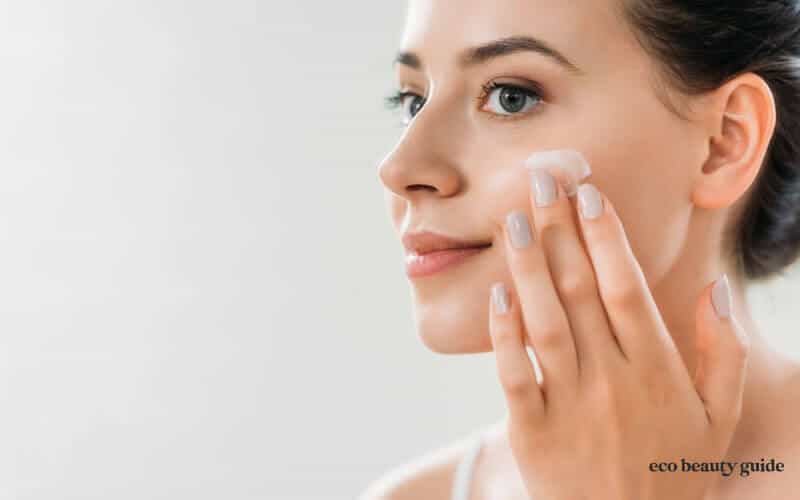 woman putting moisturizer on skin-hydrated winter skin